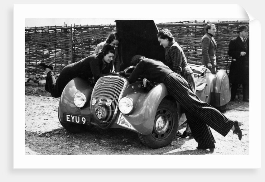 Miss MD Patten looking at the engine of a 1938 Peugeot 402 Special Sport, RAC Rally, 1939 by Unknown