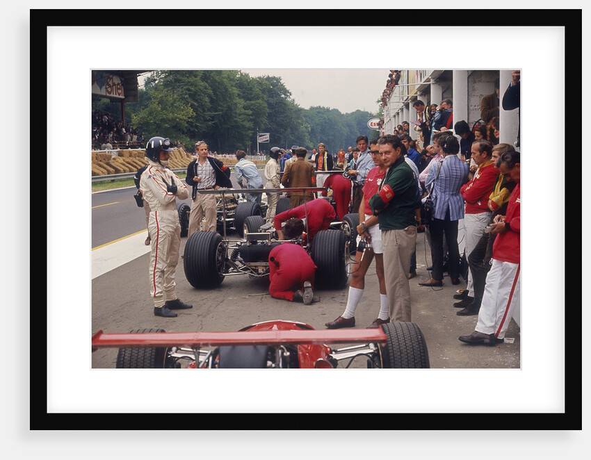 Graham Hill watches Mechanics working on a car, French Grand Prix, Rouen, 1968 by Unknown