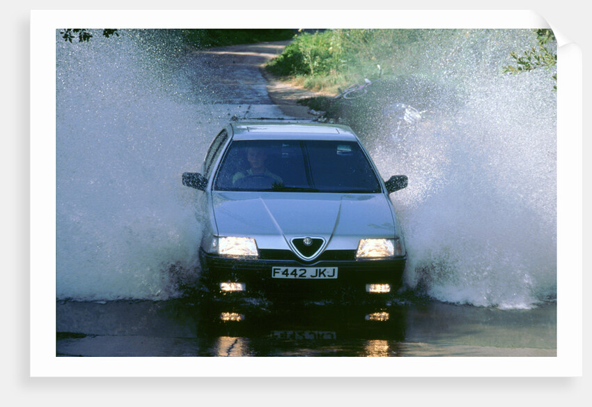 1989 Alfa Romeo 164 driving through a ford by Unknown