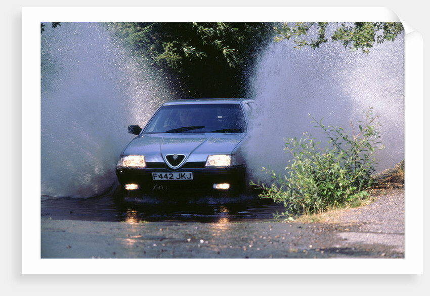 1989 Alfa Romeo 164 driving through a ford by Unknown