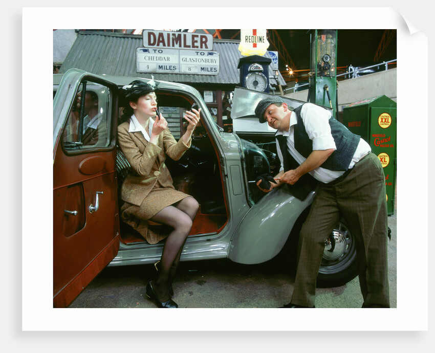 Mechanic with lady driver doing her make up, 1930's Hillman Minx by Unknown