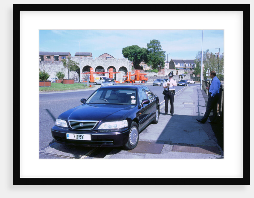 Policeman checking driver documents by Unknown