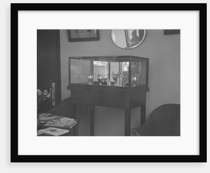 Cabinet containing motor racing trophies by Bill Brunell