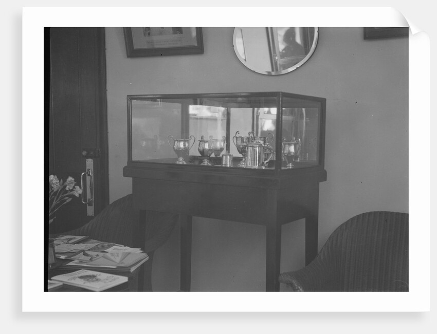 Cabinet containing motor racing trophies by Bill Brunell