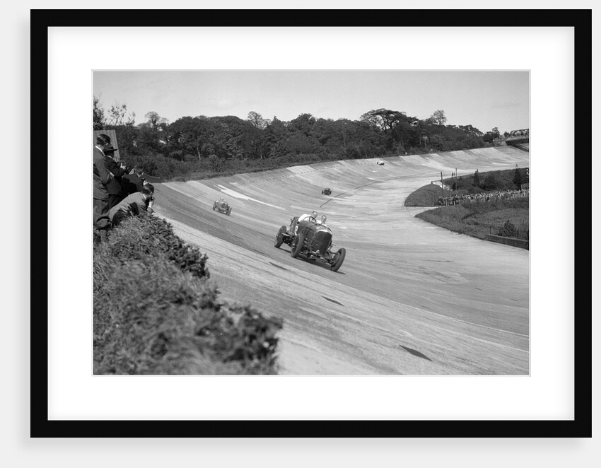 Eddie Hall's Bentley leading a Bugatti on the banking at Brooklands. by Bill Brunell