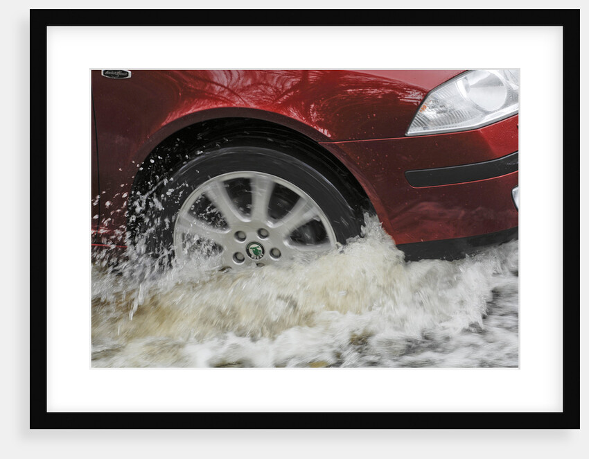Car driving through flood by Unknown