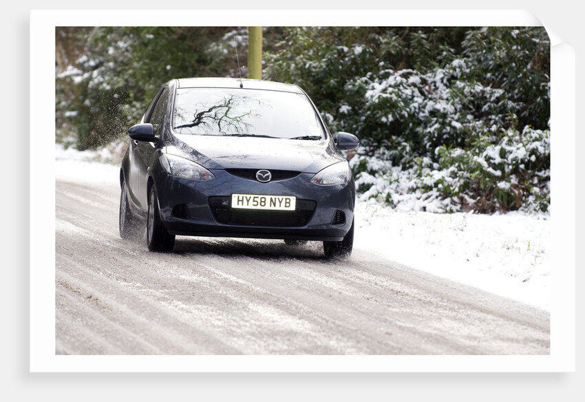 2009 Mazda 2 driving on snowy road by Unknown
