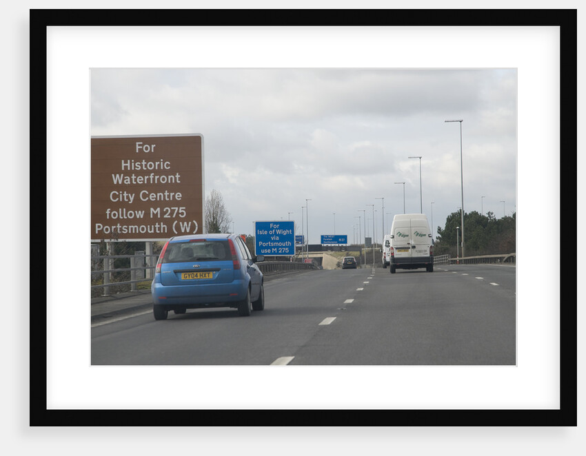 Traffic on M27 Motorway with brown tourist information sign by Anonymous