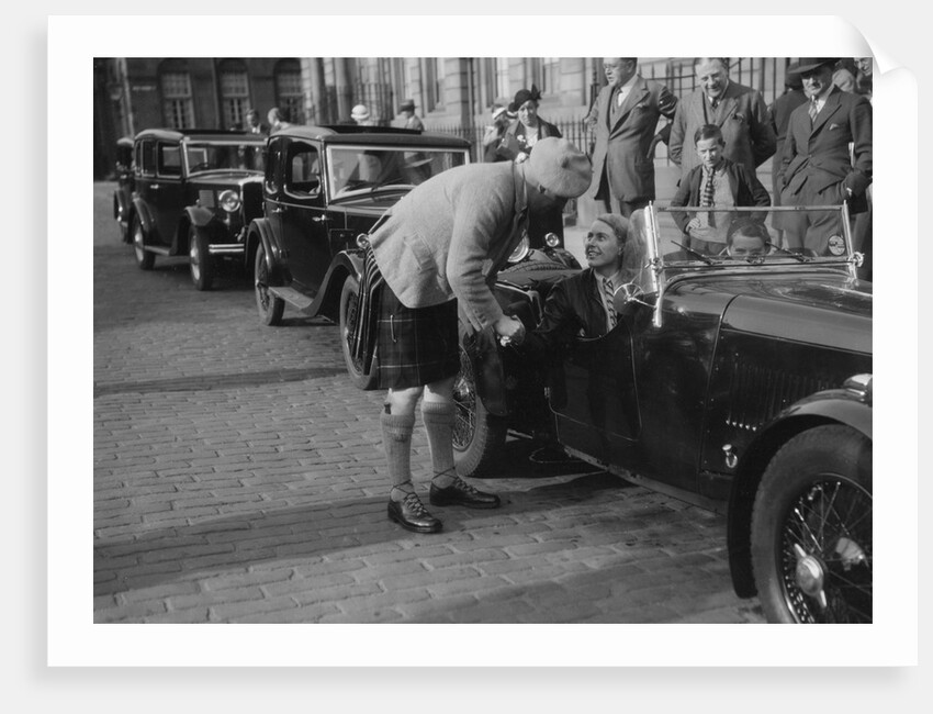 Kitty Brunell in her Aston Martin, chatting to a man in Highland dress, RSAC Scottish Rally, 1933 by Bill Brunell