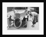 Ivy Cummings changing a tyre on a 1925 Singer 10/26, London, c1925 by Unknown