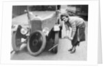 Ivy Cummings changing a tyre on a 1925 Singer 10/26, London, c1925 by Unknown
