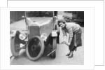 Ivy Cummings changing a tyre on a 1925 Singer 10/26, London, c1925 by Unknown