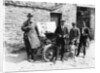 Bedford standing at the front of a car, with onlookers by Unknown