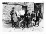 Bedford standing at the front of a car, with onlookers by Unknown