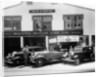 1932 Ford V8 in front of a car showroom, (c1932?) by Unknown