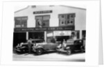 1932 Ford V8 in front of a car showroom, (c1932?) by Unknown