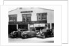 1932 Ford V8 in front of a car showroom, (c1932?) by Unknown