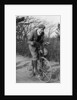 A young Lord Nuffield riding a bicycle down a country lane by Unknown