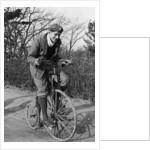 A young Lord Nuffield riding a bicycle down a country lane by Unknown