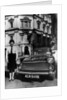 Female chauffeur standing by a 1964 Morris Oxford, 1964 by Unknown