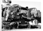 Old cars piled up in a scrapyard, Britain by Unknown