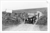 A Morris Bullnose driving through a gateway, early 1920s by Unknown