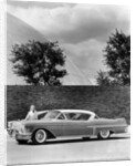 Woman with a 1957 Cadillac coupe de ville by Anonymous