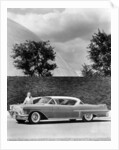 Woman with a 1957 Cadillac coupe de ville by Anonymous