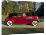 A 1936 Auburn 852 car on a gravel driveway in the autumn sunlight by Unknown