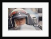 Jackie Stewart at the wheel of a racing car by Unknown