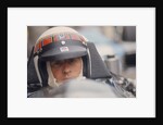 Jackie Stewart at the wheel of a racing car by Unknown