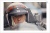 Jackie Stewart at the wheel of a racing car by Unknown
