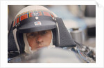 Jackie Stewart at the wheel of a racing car by Unknown