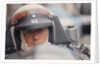 Jackie Stewart at the wheel of a racing car by Unknown