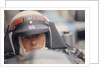 Jackie Stewart at the wheel of a racing car by Unknown