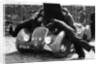 Miss MD Patten looking at the engine of a 1938 Peugeot 402 Special Sport, RAC Rally, 1939 by Unknown