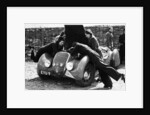 Miss MD Patten looking at the engine of a 1938 Peugeot 402 Special Sport, RAC Rally, 1939 by Unknown