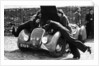 Miss MD Patten looking at the engine of a 1938 Peugeot 402 Special Sport, RAC Rally, 1939 by Unknown