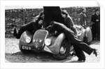 Miss MD Patten looking at the engine of a 1938 Peugeot 402 Special Sport, RAC Rally, 1939 by Unknown