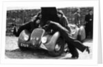 Miss MD Patten looking at the engine of a 1938 Peugeot 402 Special Sport, RAC Rally, 1939 by Unknown