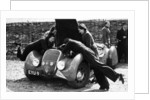 Miss MD Patten looking at the engine of a 1938 Peugeot 402 Special Sport, RAC Rally, 1939 by Unknown