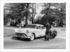 An Oldsmobile at the corner of an American street, 1954 by Unknown