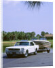 1967 Ford Mustang towing a boat by Unknown