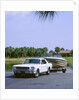 1967 Ford Mustang towing a boat by Unknown