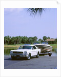 1967 Ford Mustang towing a boat by Unknown