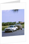 1967 Ford Mustang towing a boat by Unknown