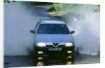 1989 Alfa Romeo 164 driving through a ford by Unknown
