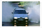1989 Alfa Romeo 164 driving through a ford by Unknown