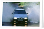 1989 Alfa Romeo 164 driving through a ford by Unknown