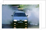 1989 Alfa Romeo 164 driving through a ford by Unknown